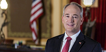 A picture of Auditor Keith Faber with an American Flag in the background